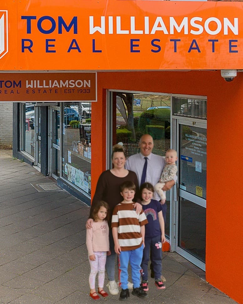 Tom and Virginia Williamson with their family outside the office, 2026